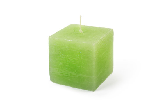 Green cube-shape candle on white background