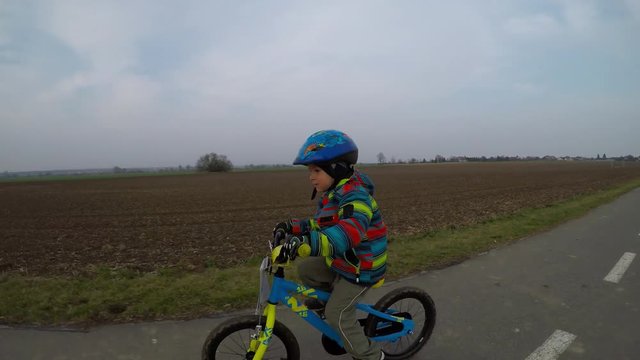 Cute little boy riding a bike.
Boy riding a bike along the cycle path.