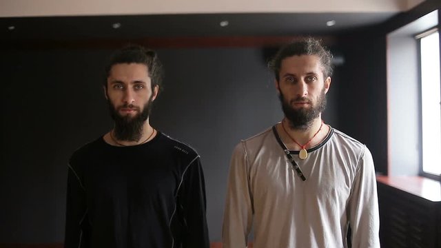 Portrait of the fighters tai chi twin brothers in the training hall