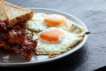 Ham and Egg. Bacon and Egg. Salted egg and sprinkled with black pepper. English breakfast.