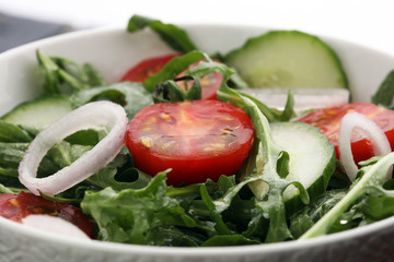 Bowl of salad on wooden table