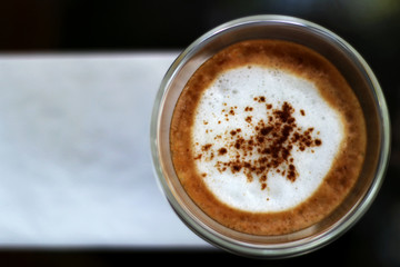 Glass of hot cappuccino coffee