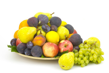 fresh fruits on a plate on white background