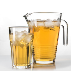 drink a jug into a glass on white background