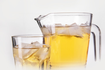 drink a jug into a glass on white background