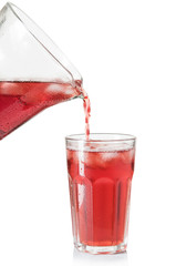 drink a jug into a glass on white background