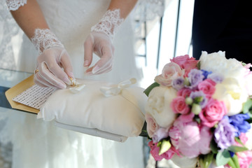 Bride takes wedding rings during wedding ceremony