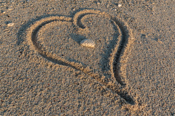 Fototapeta na wymiar A heart shape in the sand