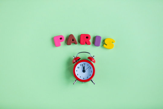 photo of alarm clock and colorful letters on the wonderful green studio background