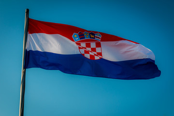 Croatian Flag flying on a blue background