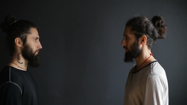 Portrait of the fighters tai chi twin brothers in the training hall