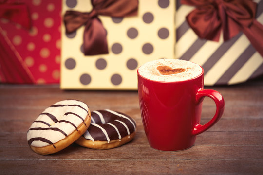 photo of cup of coffee and donuts on the wonderful gifts background
