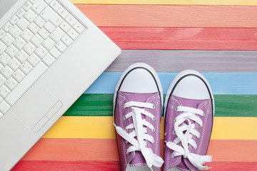 photo of gumshoes and laptop on the wonderful colorful background in pop art style