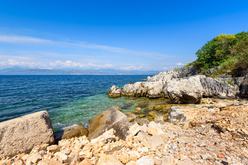 Picturesque rocky bay in Kassiopi village, located in northern Corfu. Greece.