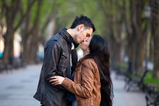 photo of cute couple kissing and hugging on the wonderful park background