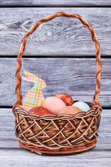 Eggs in a basket. Colorful Easter rabbit cutout.
