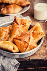 Tasty baked pasties and a glass of milk, homemade food
