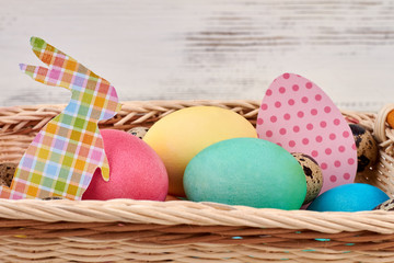 Painted eggs and paper cutouts. Bright colored Easter eggs.