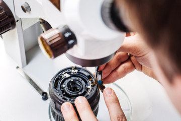 Camera lens repair set in photo engineer workshop.
