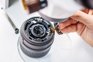 Camera lens repair set in photo engineer workshop.