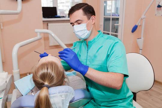 Dentist is treating teeth for a woman