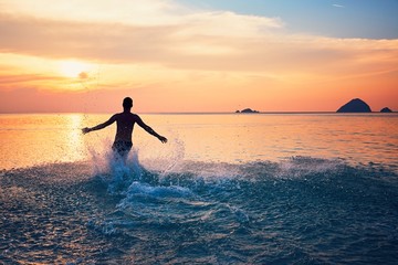 Man running into the sea