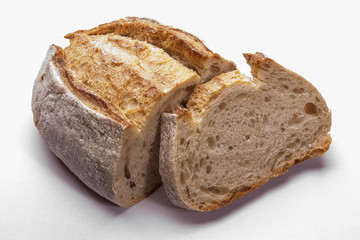 Rustic bread on an white. Country house style. Authentically.