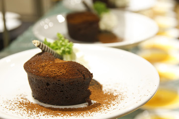 chocolate brownie cake with cocoa powder and wafer for dessert sweet food on white dish in bakery cafe restaurant and warm white
