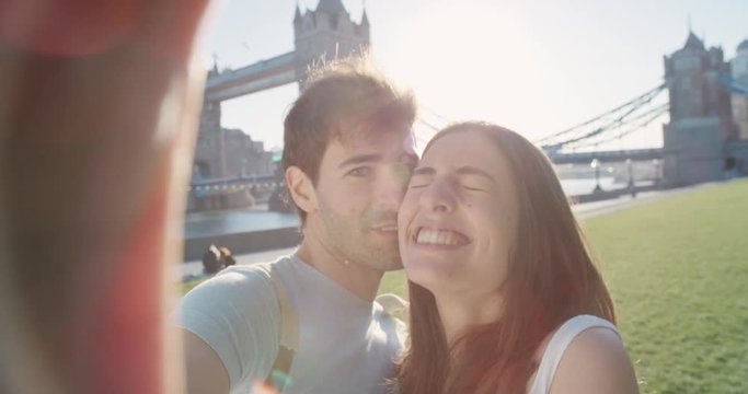 Tourist couple taking selfie smartphone in city sharing lifestyle photo enjoying  holiday European   vacation travel adventure London POV