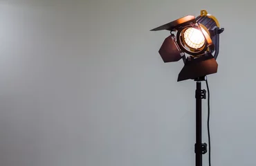 Fotobehang Spotlight with halogen bulb and Fresnel lens. Lighting equipment for Studio photography or videography. © Andrey Lapshin