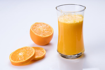 glass of orange juice on white table