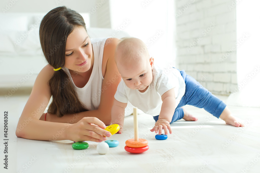 Wall mural Mom plays with the baby  