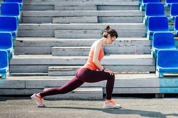 Sport, exercises outdoors. Girl on stadium.