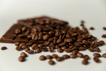 close-up coffee beans and chocolate on a white background.