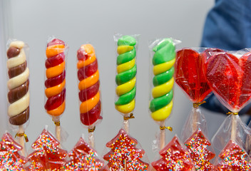 Sweet glazed andy lollipops for sale on farmer market or country fair.