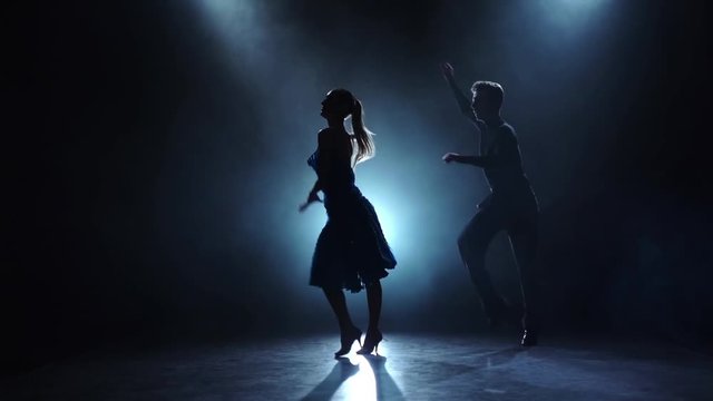 Dance cha-cha-cha performed by a professional couple in slow motion