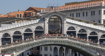 Detail of the top of the famous Rialto bridge on a sunny day with crowd of visitors, Venice, Italy