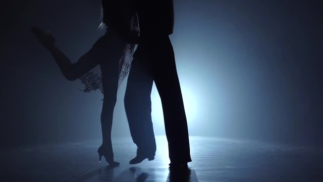 Dance couple demonstrating magnificent choreography of tango, slow motion. Close-ups
