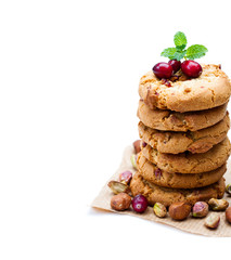 Stack  of oat cookies with cranberry and pistachio isolated on white