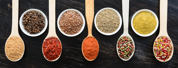 Various spices on wooden spoons. Food ingredients