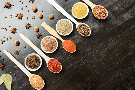 Various spices on wooden spoons. Food ingredients