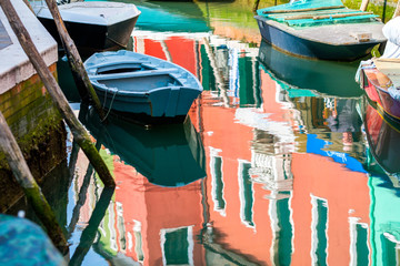 Fototapeta na wymiar Boats and buildings reflect water