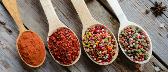 Various spices on wooden spoons. Food ingredients