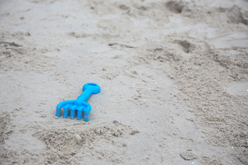 blue plastic sand construction toy isolated on sand beach