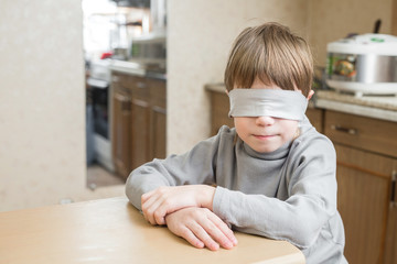 The child was blindfolded at home.