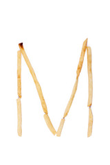 Alphabet letter M laid with french fries. Alphabet letter food.