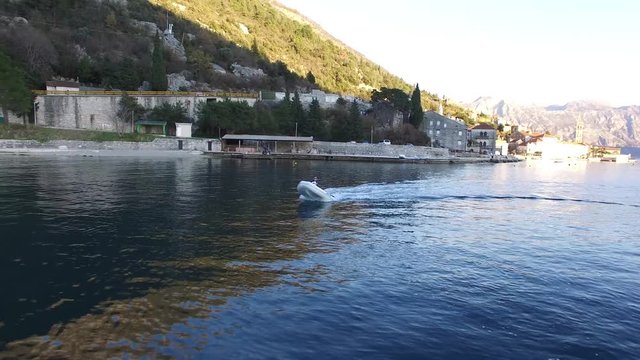 Speed Dinghy at high speed sailing on the sea. Kotor Bay in Montenegro.