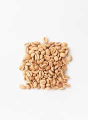 Grains of green coffee on a white background
