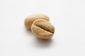 Grains of green coffee on a white background