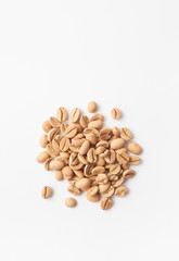 Grains of green coffee on a white background